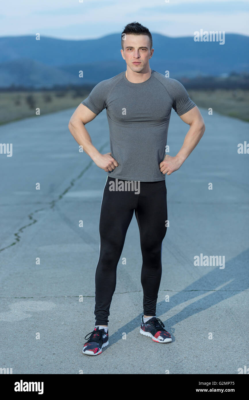 Jeune sportif jogging dans la ville de nuit Banque D'Images