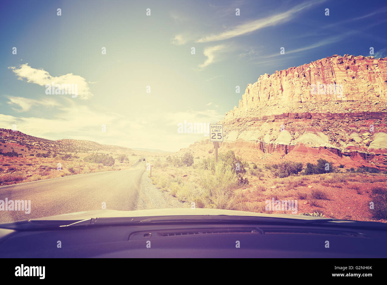 Vintage photo aux couleurs d'une route contre sun avec limite de vitesse signe du siège avant d'une voiture, travel concept, USA. Banque D'Images