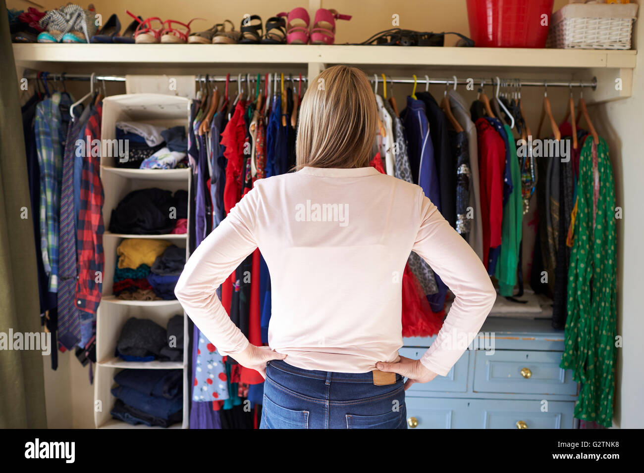 Femme de chambre à la recherche de vêtements dans l'armoire Photo Stock -  Alamy