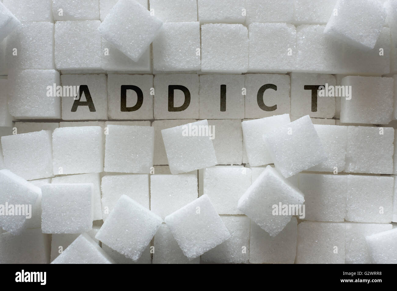 Le sucre en cubes et 'addict' inscription Banque D'Images