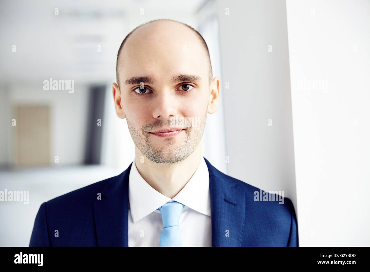 Portrait of young businessman calme dans le bureau. Fond clair. Close up. Banque D'Images