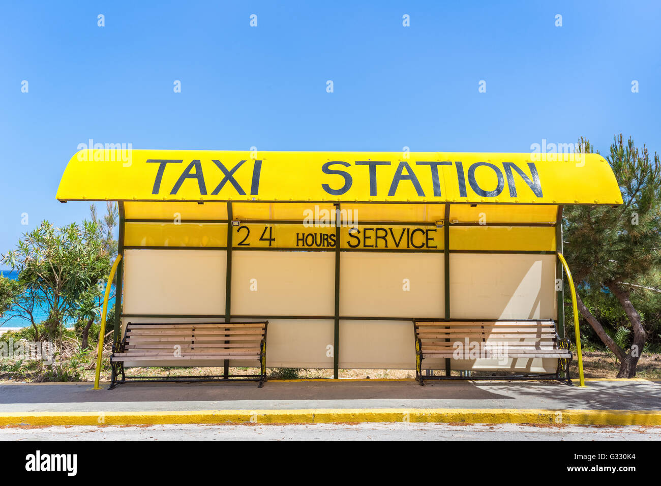 Station de taxi jaune à l'autre en Grèce avec deux bancs Banque D'Images