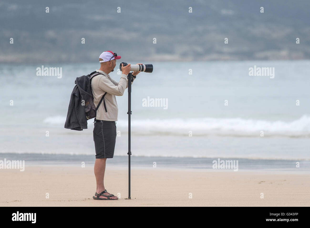 Un photographe sur la plage de Fistral, Newquay, Cornwall. Banque D'Images