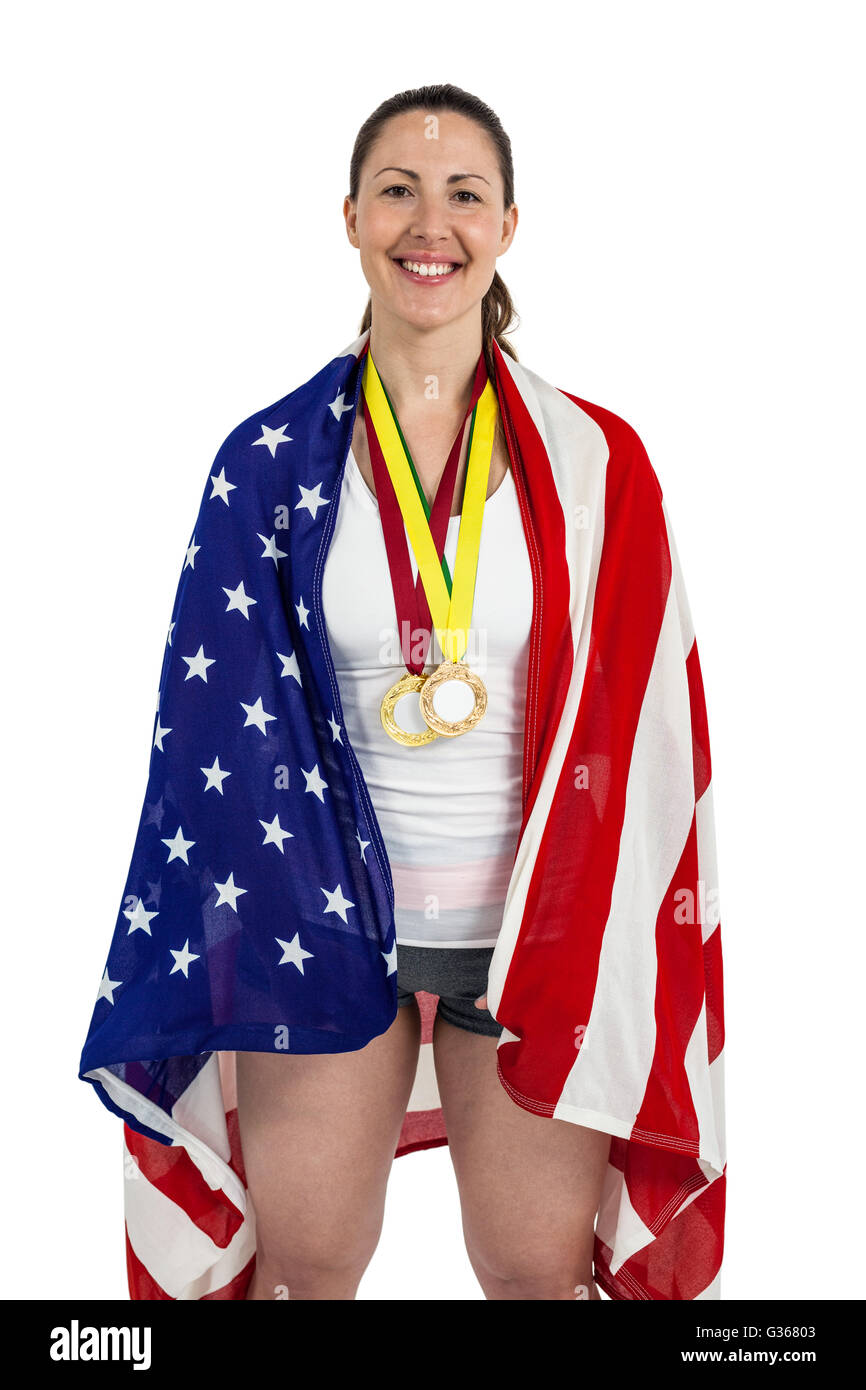 Athlète posant avec drapeau américain et des médailles d'or autour du cou Banque D'Images
