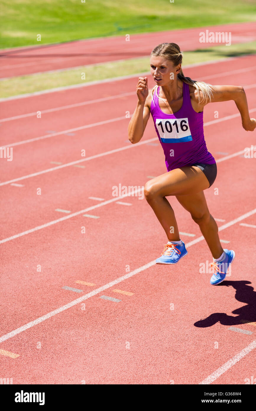 Athlète féminin exécutant sur la piste de course Banque D'Images