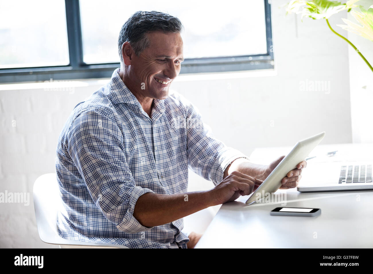 Businessman typing on his tablet computer Banque D'Images