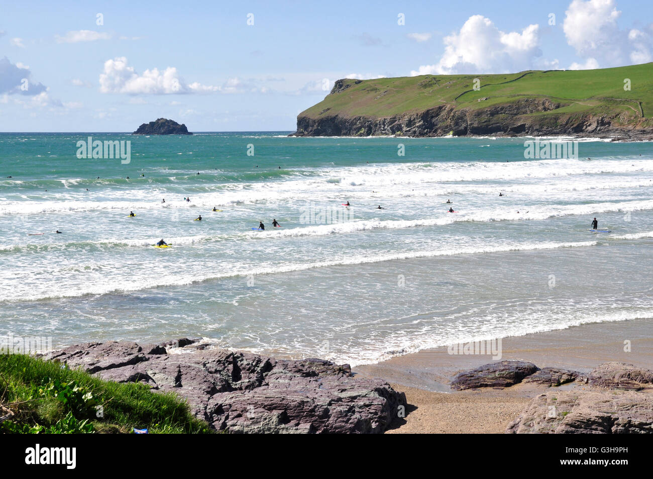 Plage de Polzeath - Cornwall - la flambée des vagues - surfers plafonné blanc - toile tête Pentire -mer bleue et le ciel - la lumière du soleil Banque D'Images