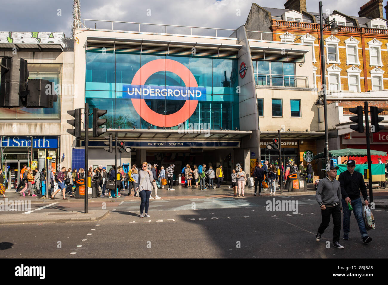 Les personnes en attente ou à pied en face de l'entrée de la station de métro de Brixton, dans le sud de Londres Banque D'Images