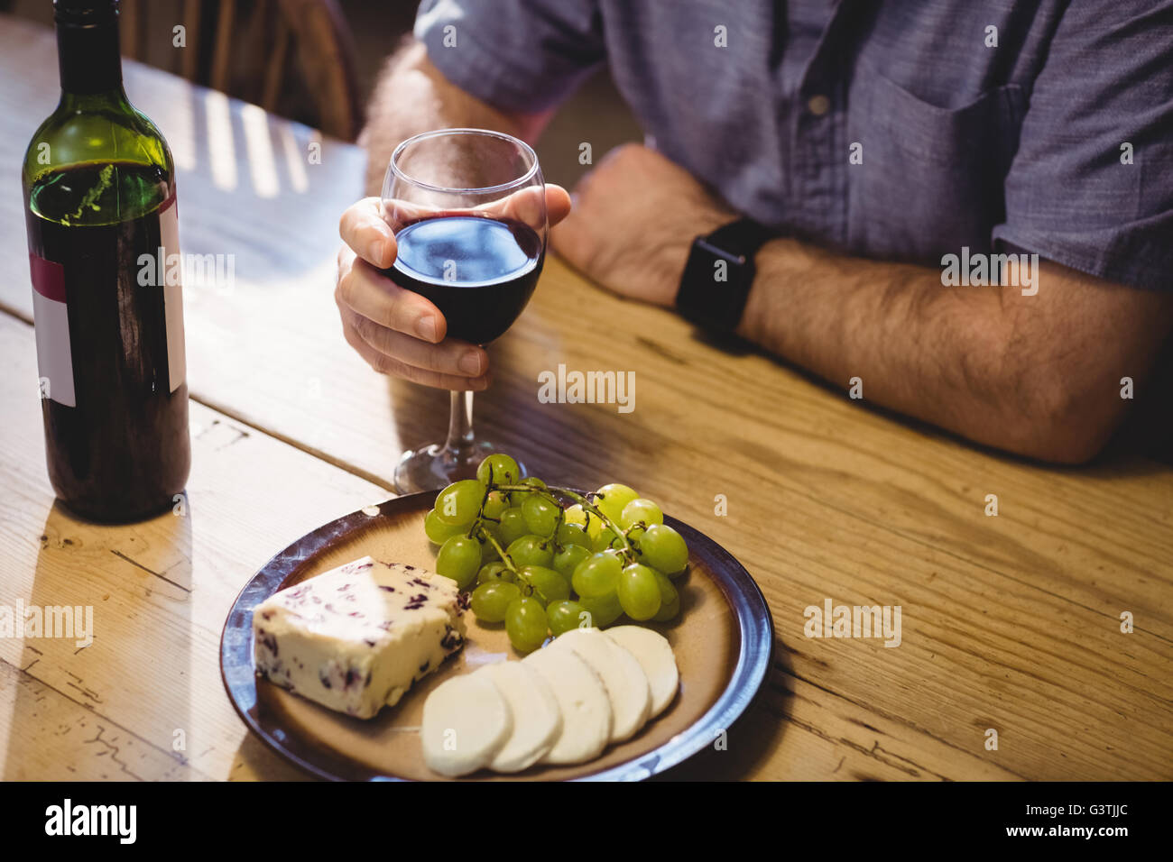 Vue rapprochée de fromage plateau et verre de vin attente par man Banque D'Images
