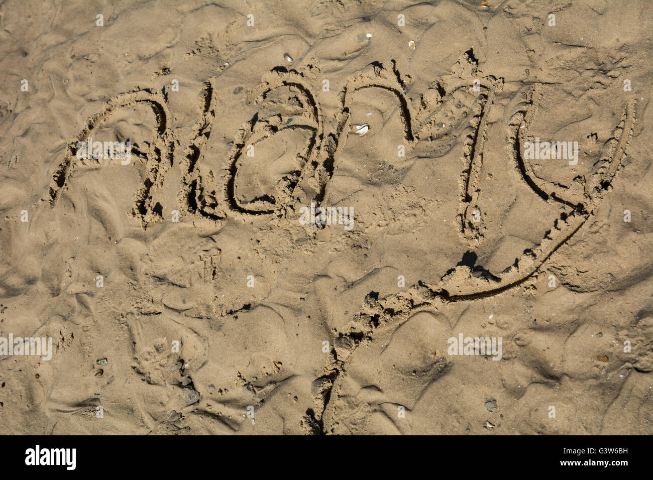 Le mot "Alamy' dessiné dans le sable. Banque D'Images