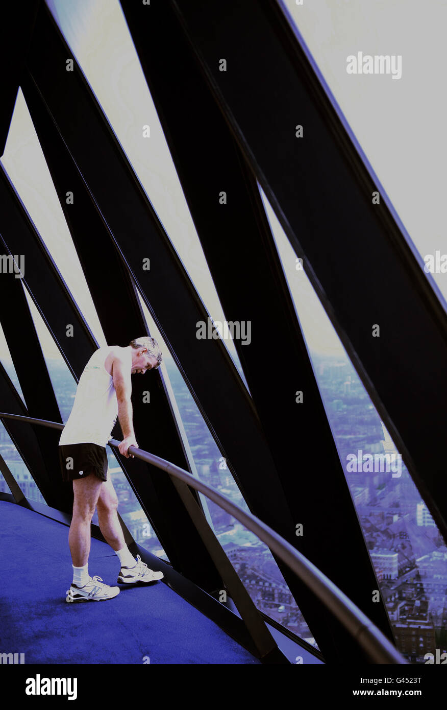 Un concurrent se remet alors que plus de 500 personnes font 1037 marches pour atteindre le sommet du bâtiment Gherkin de Londres, à l'aide de l'événement changement d'étape de la NSCPCC. Banque D'Images