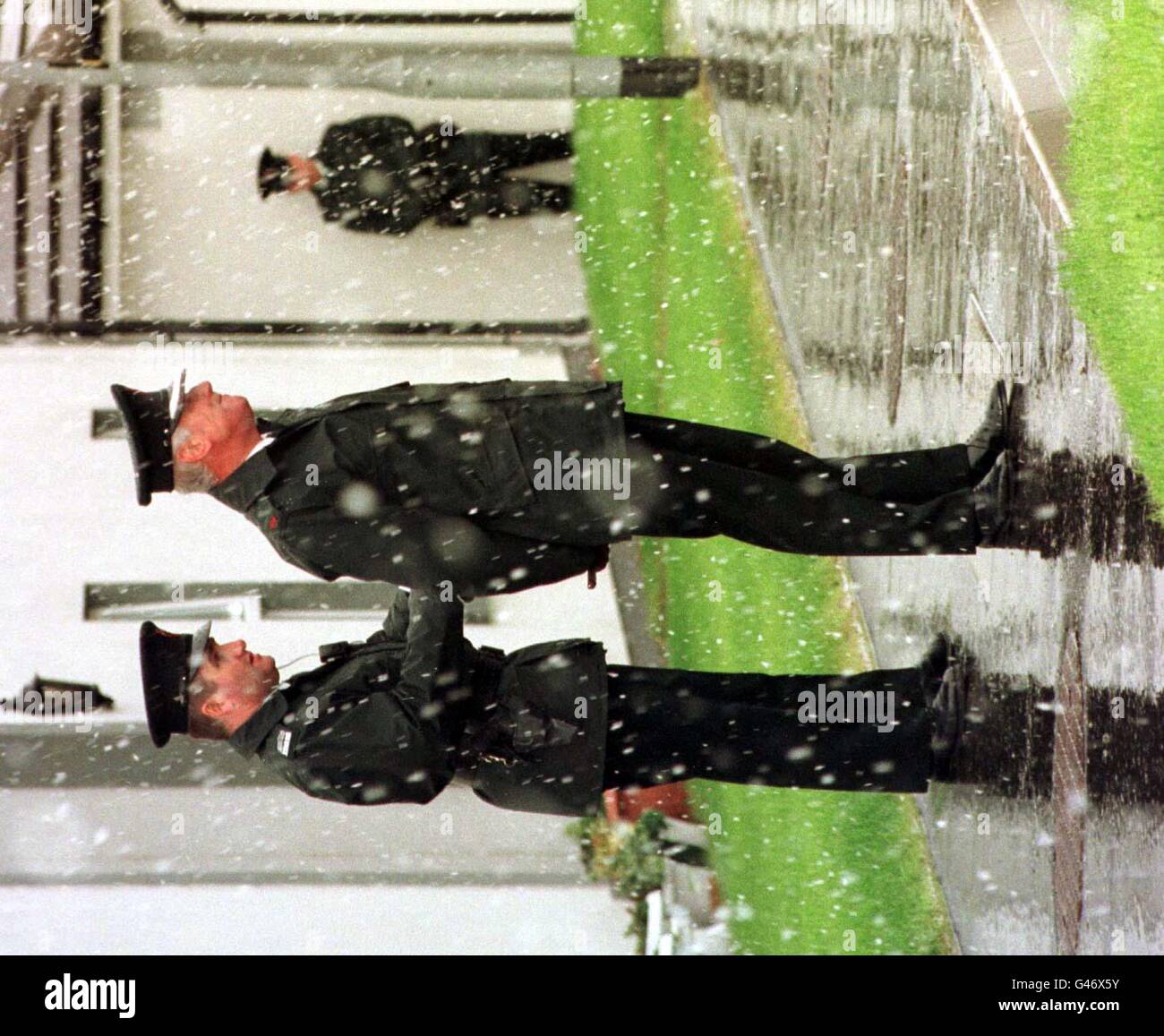 RUC Officer attend dans un blizzard de neige pour l'arrivée du Prince Charles à la North Belfast Mission Housing Society aujourd'hui (mardi) à Wesley court, à Carrickfergus, le premier jour de son voyage de deux jours en Irlande du Nord. Photo Tim Ockenden/PA Banque D'Images