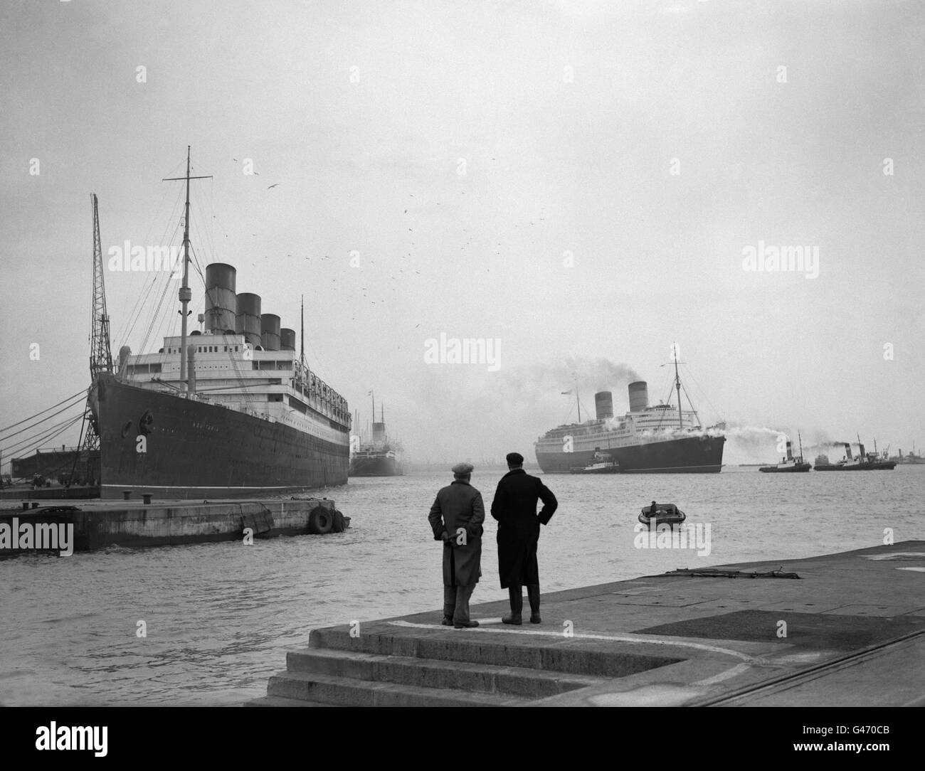 Trois navires Cunard arrivent sur les quais de Southampton. RMS Queen Elizabeth (à droite) se dirigeant vers le quai sec du roi George V pour sa révision d'hiver; (à gauche) se trouve le RMS Aquitania, qui repose à Berth 108, avant de poursuivre son dernier voyage vers le chantier des brise-roches; et en arrière-plan (à gauche) est le RMS Mauretania, à Berth 106. Banque D'Images