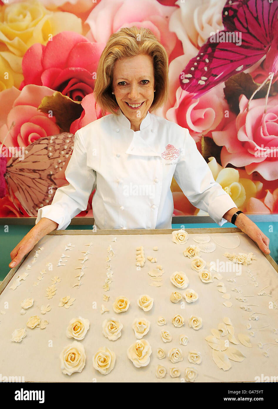 Le concepteur de gâteaux Fiona Cairns, qui a été commandé par le Prince William et Kate Middleton pour créer un gâteau aux fruits traditionnel à plusieurs niveaux, somptueusement décoré avec un thème floral pour leur mariage, tient un plateau de décorations pour le gâteau à Fleckney, Leicestershire. Banque D'Images