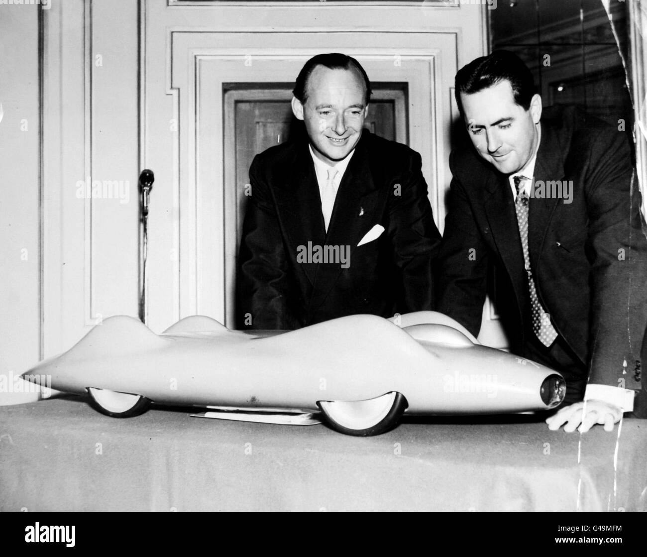 Record de vitesse terrestre - Donald Campbell Party et réception - Cafe Royal, Londres.Donald Campbell et Jack Brabham, le champion mondial de la course automobile, avec un modèle de la voiture que M. Campbell va tenter de relever. Banque D'Images