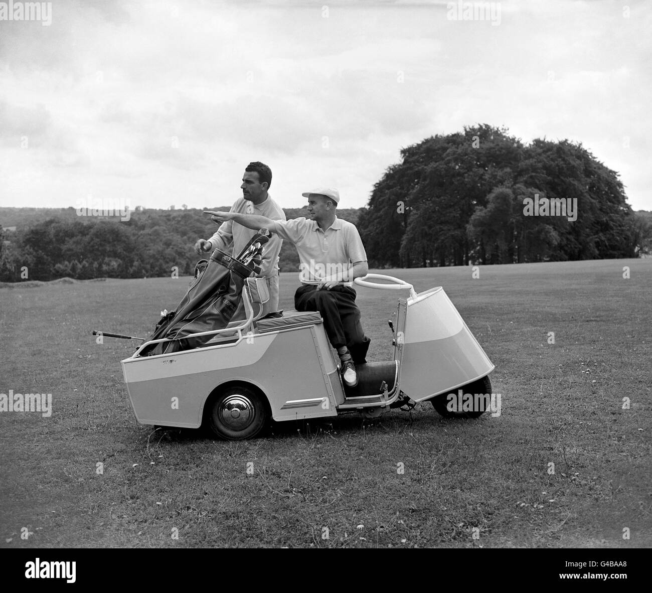 De gauche à droite, Leopoldo Ruiz de l'Argentine, et Sid Scott avec l'une des nouvelles voitures de berceau électriques. Ils viennent avec des ensembles talkie-walkie pour relayer l'état du jeu au tableau de score. Banque D'Images