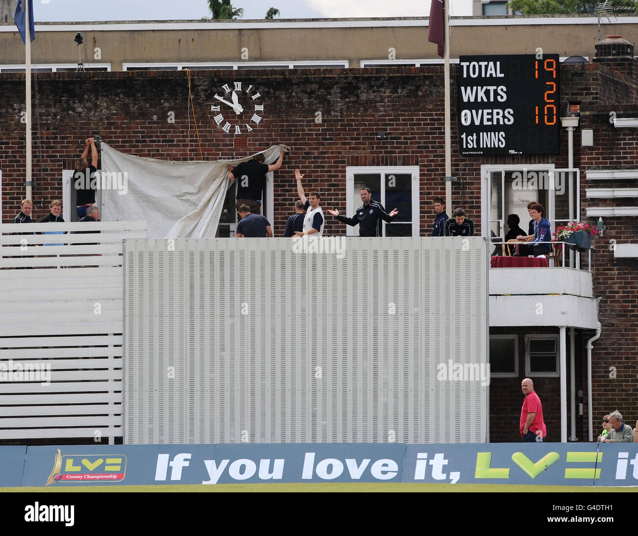 Le personnel au sol du CC Guildford a mis en place un écran de site temporaire pendant le match de Surrey contre Middlesex. Banque D'Images