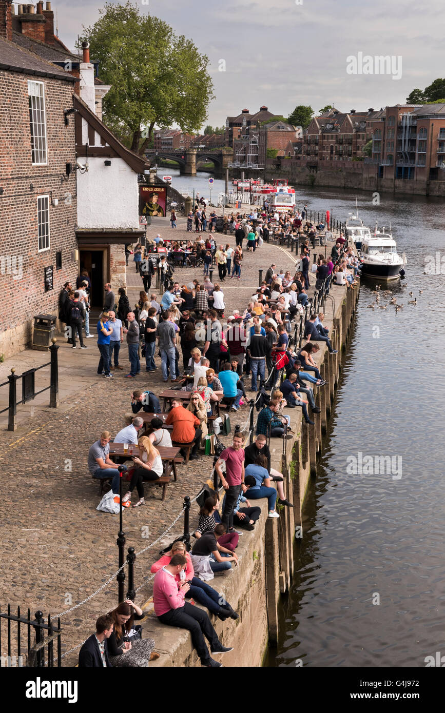 Beaucoup de gens boivent et se détendent dans un pub animé au bord de la rivière (King's Arms) et des bateaux de loisirs sur River Ouse - King's Staith, York, North Yorkshire, Angleterre. Banque D'Images