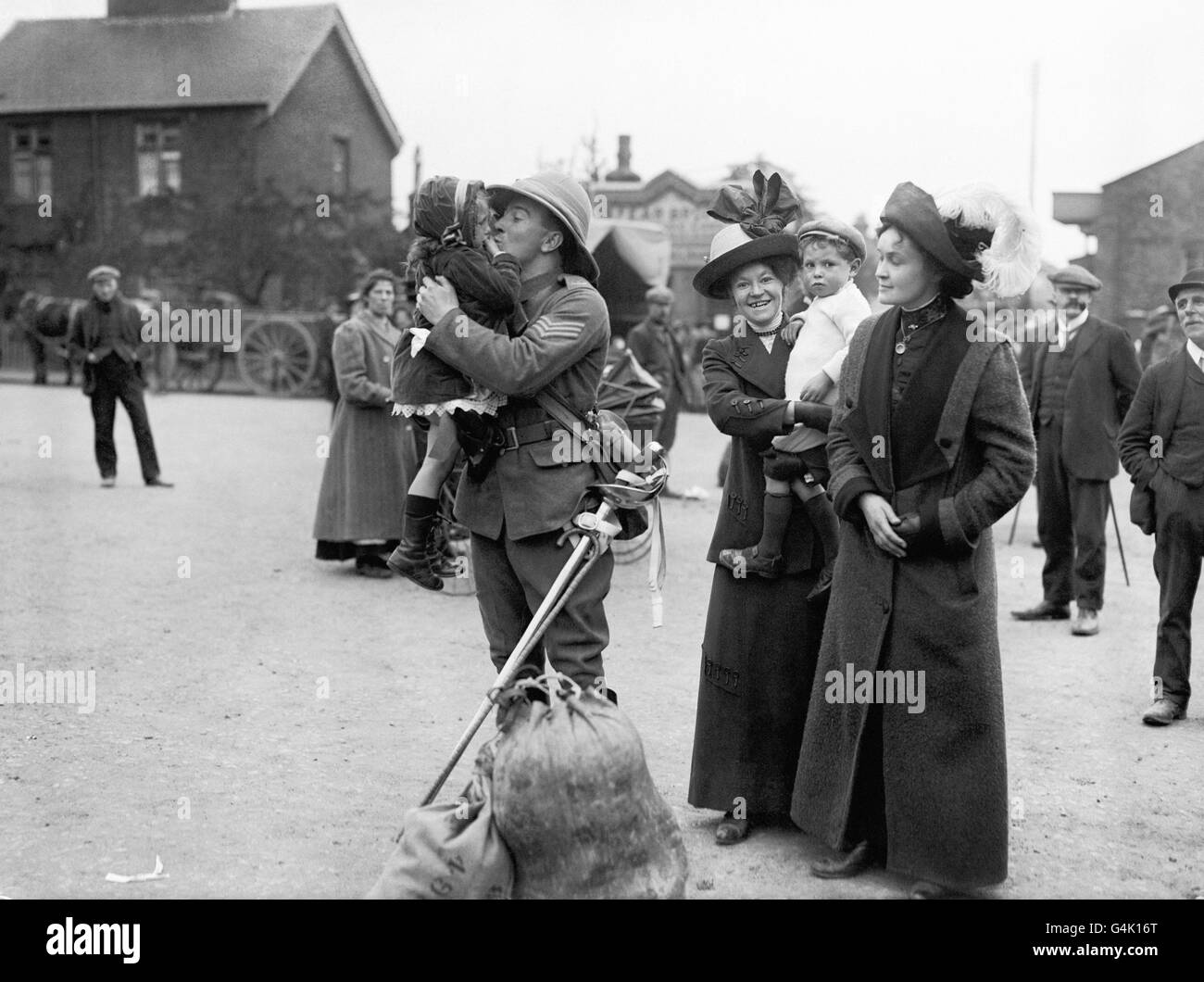 Un soldat britannique de la 3e (Prince de Galles) Dragoon Guards embrasse un enfant avant de partir pour la France en août 1914. Banque D'Images