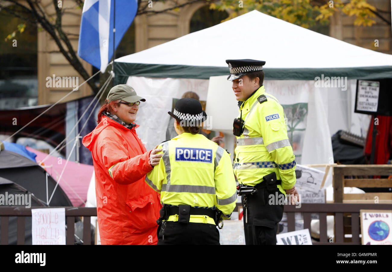 Un manifestant qui ne veut être nommé que Toni est avec des policiers au camp de Occupy Glasgow à George Square à Glasgow. Banque D'Images