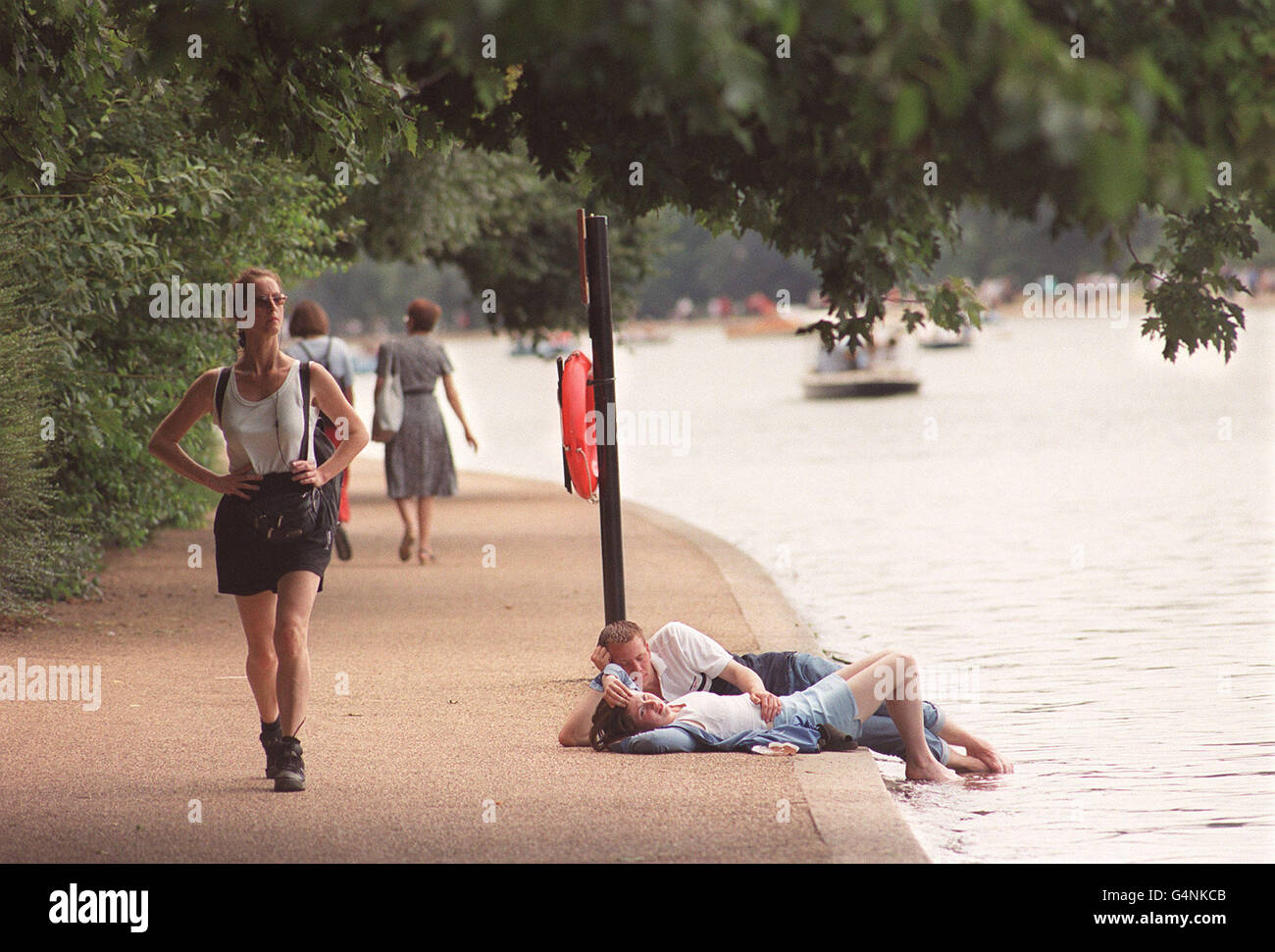Les baigneurs de soleil se détendent près de la Serpentine, dans Hyde Park à Londres, alors que les températures ont atteint les années 80, sur ce qui est prévu pour être le week-end le plus chaud de l'année. Banque D'Images