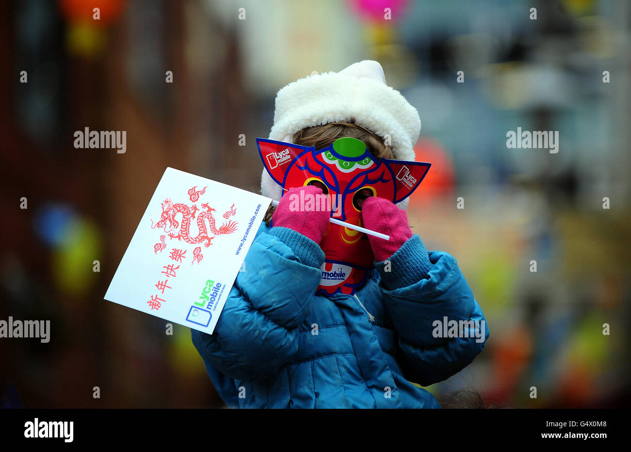 Un enfant portant un masque dragon pendant les célébrations du nouvel an chinois au Centre Arcadian de Birmingham. Banque D'Images