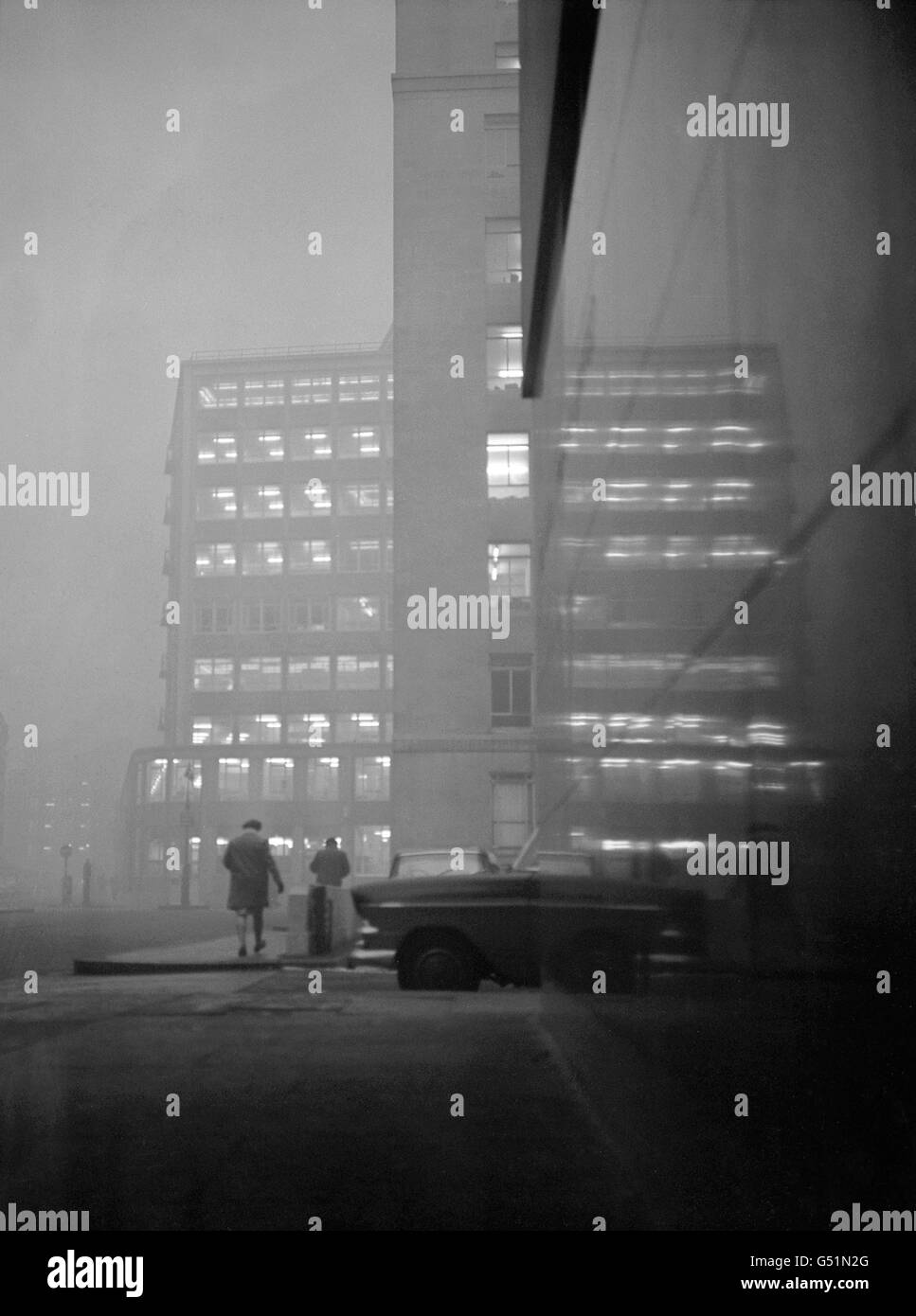 Les lumières de Londres brillent à travers le brouillard qui descendit sur la ville tôt ce matin. Cette photo, prise à 14h30, a montré l'étendue du mauvais temps, et un porte-parole du ministère de l'Air a déclaré que le brouillard était là pour rester la soirée et serait lent à se dégager demain Banque D'Images