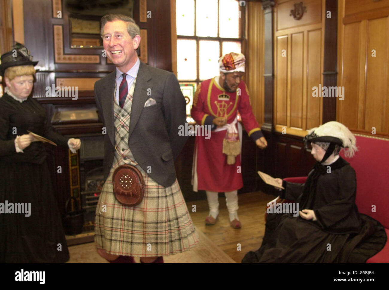 Le Prince Charles ouvre la vieille gare de Ballater, Nr Balmoral.À droite, une exposition grandeur nature de la reine Victoria attend de prendre son dernier train en 1900 de la gare avec son Mushi, Abdul Karim et sa fille la princesse Beatrice (à gauche). Banque D'Images