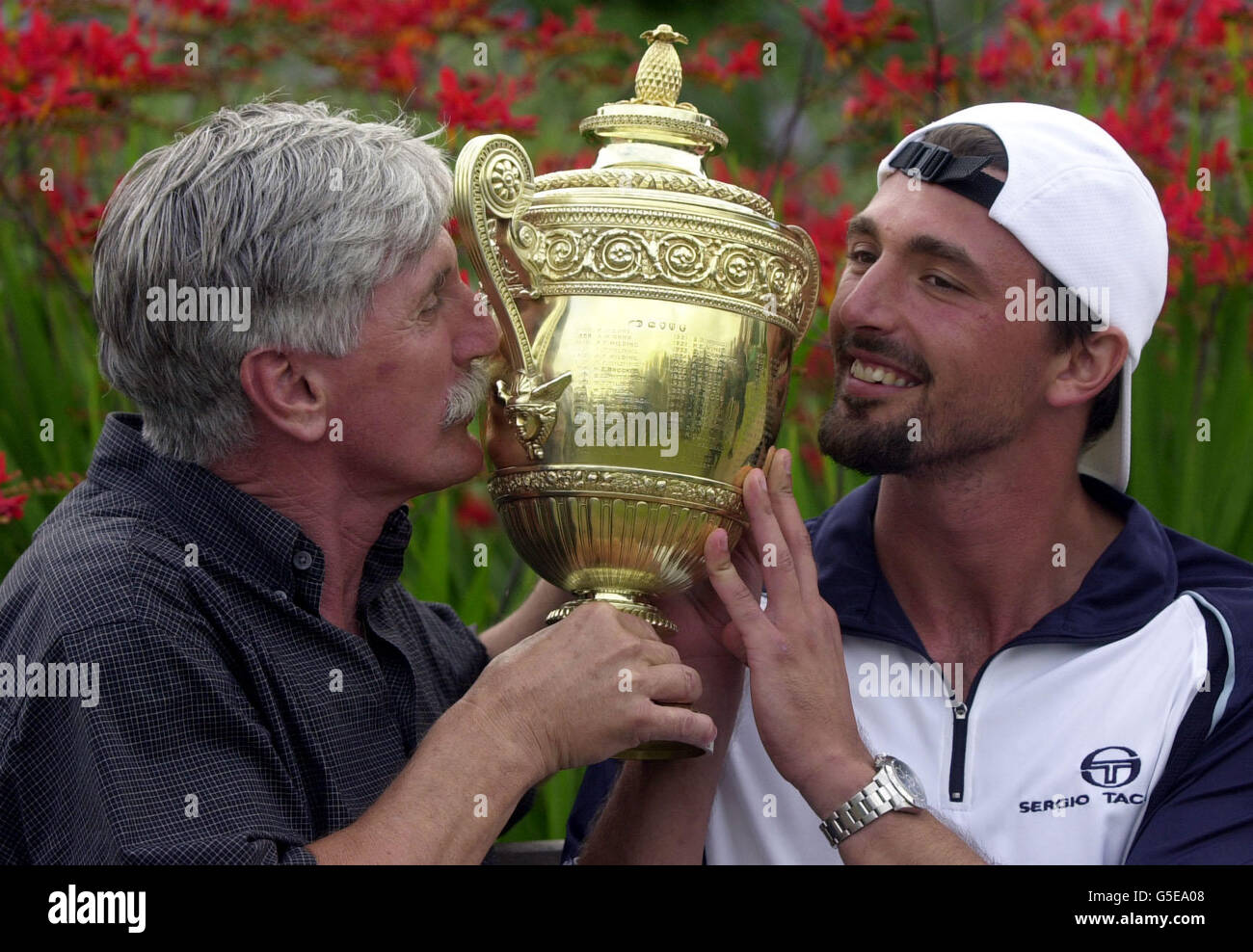 Goran Ivanisevic, de Croatie, célèbre avec son père Srdjan et le trophée après avoir battu l'australien Pat Rapher lors de la finale des hommes des Championnats de tennis de pelouse 2001 à Wimbledon, Londres. Ivanisevic a gagné 6-3, 3-6, 6-3, 2-6, 9-7 . Banque D'Images