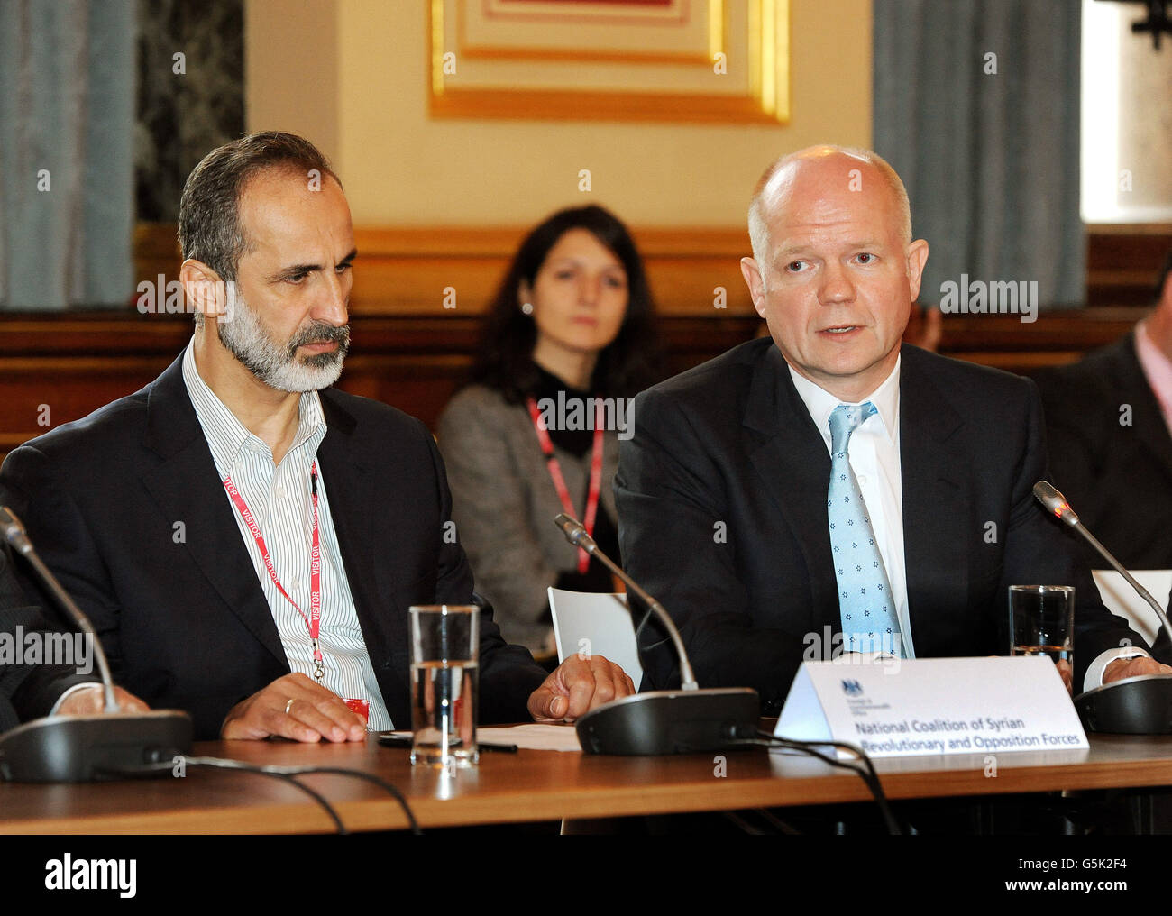 Le secrétaire aux Affaires étrangères William Hague accompagne le président Sheikh Ahmed Mu'az Al-Khatb du mouvement d'opposition syrien, dans la réunion sur la poursuite du conflit en Syrie, au bureau des Affaires étrangères et du Commonwealth à Whitehall, dans le centre de Londres. Banque D'Images