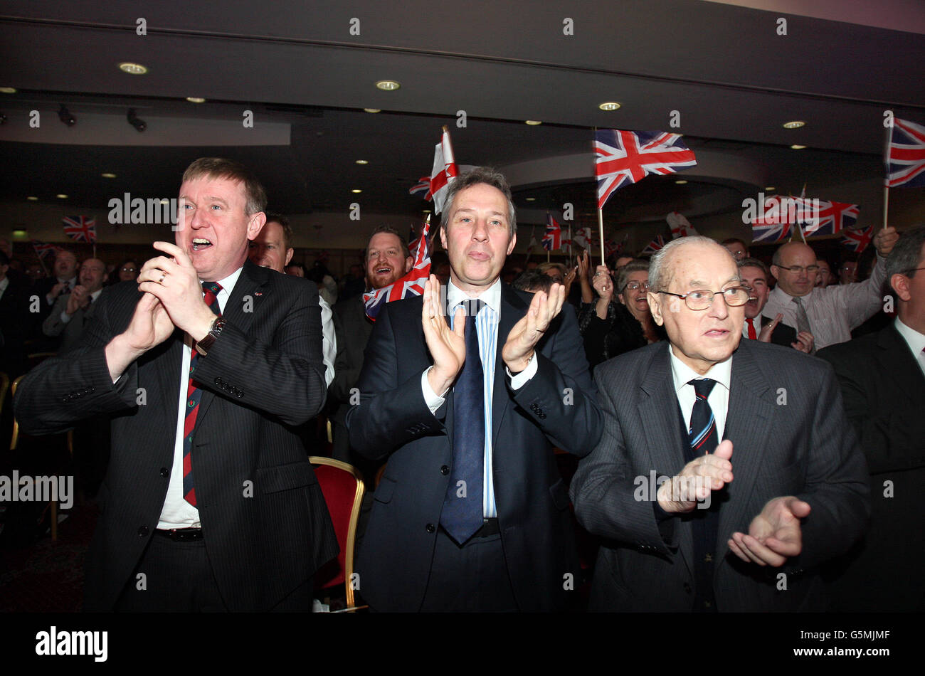 Ian Paisley Jnr MP, (au centre) avec des collègues du parti applaudissent Peter Robinson Chef du DUP et Premier ministre d'Irlande du Nord à la conférence annuelle du parti, à l'hôtel la mon House, à l'extérieur de Belfast. Banque D'Images