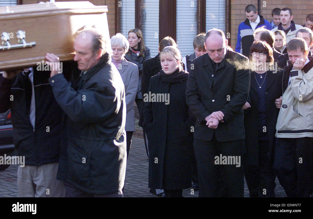 Lindsay Milliken (gauche, cheveux blonds) la petite amie de Daniel McColgan, marche derrière son cercueil avec sa famille, à ses funérailles sur le domaine de Rathcoola, dans le nord de Belfast. *M. McColgan a été tué par balle lorsqu'il est arrivé au travail tôt samedi matin dans un bureau de triage dans le domaine de Rathcoola, un loyal et farouchement loyal. Le meurtre a été revendiqué par les Red Hand Defenders qui ont menacé que d'autres employés postaux catholiques soient également des cibles légitimes. Tous les travailleurs postaux d'Irlande du Nord ont organisé un arrêt de 24 heures pour marquer le respect de leur collègue assassiné et d'un grand nombre de ceux qui ont travaillé Banque D'Images