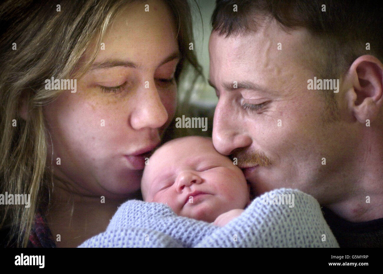 7lb Baby Nicholas s'endort avec sa mère Kathryn Hurley et le père Paul Craig de Tranent près d'Édimbourg, à l'hôpital de maternité Simpson à Édimbourg, après être né à 14 minutes après minuit le 25/12/01.* Nicholas peut être le dernier bébé de Noël à être né à l'hôpital car il doit se déplacer à un nouveau site l'année prochaine. Banque D'Images
