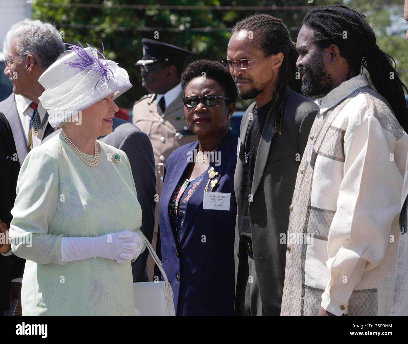 La reine Elizabeth II de Grande-Bretagne rencontre les rastafariens Ziggy Soul (2e à droite) et Lloyd 'Juba' Johnson, à l'école Hugh Sherlock Trenchtown, en Jamaïque, lors de sa tournée à l'étranger Jubilé. Banque D'Images