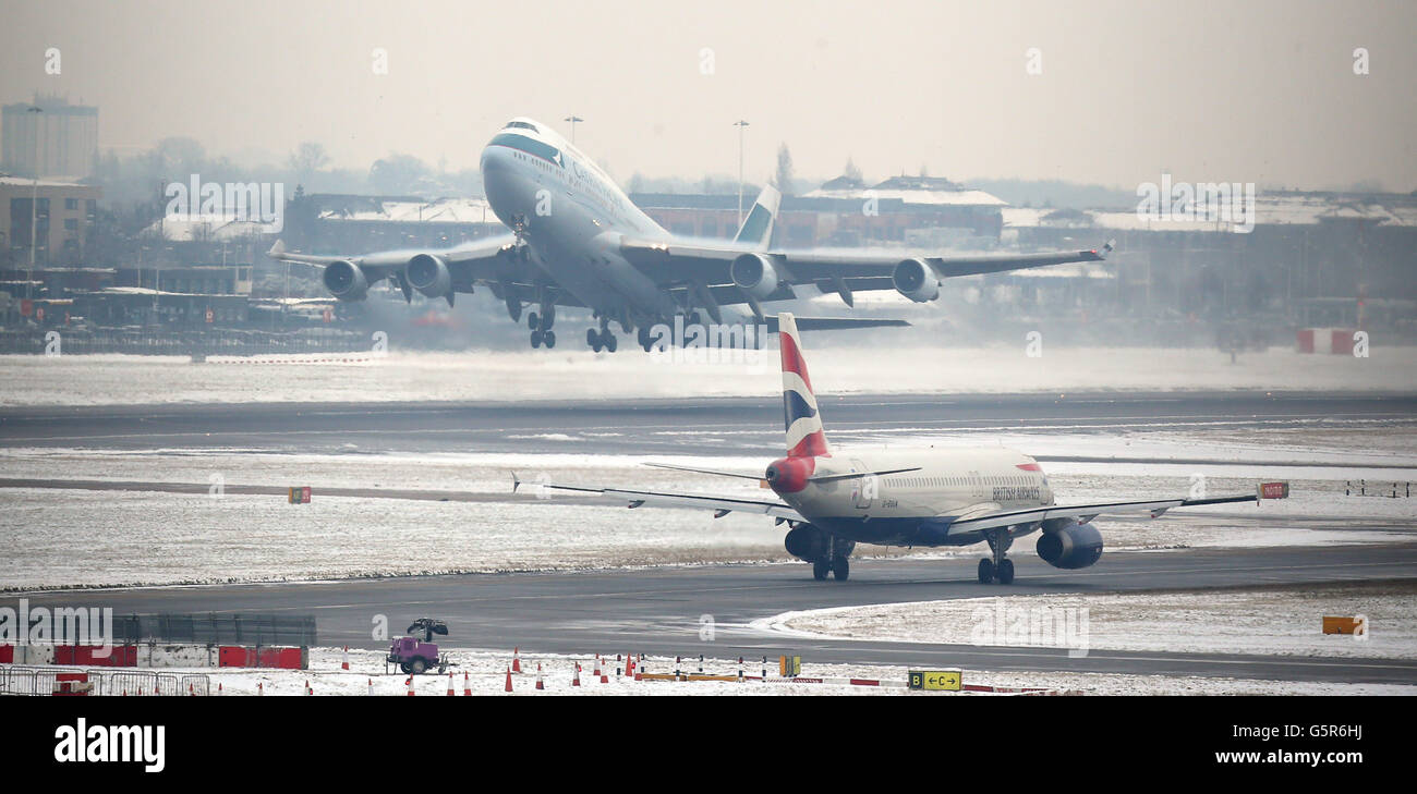 Les avions prennent le décollage et le taxi à l'aéroport d'Heathrow pendant que le temps d'hiver a continué à travers le Royaume-Uni. Banque D'Images