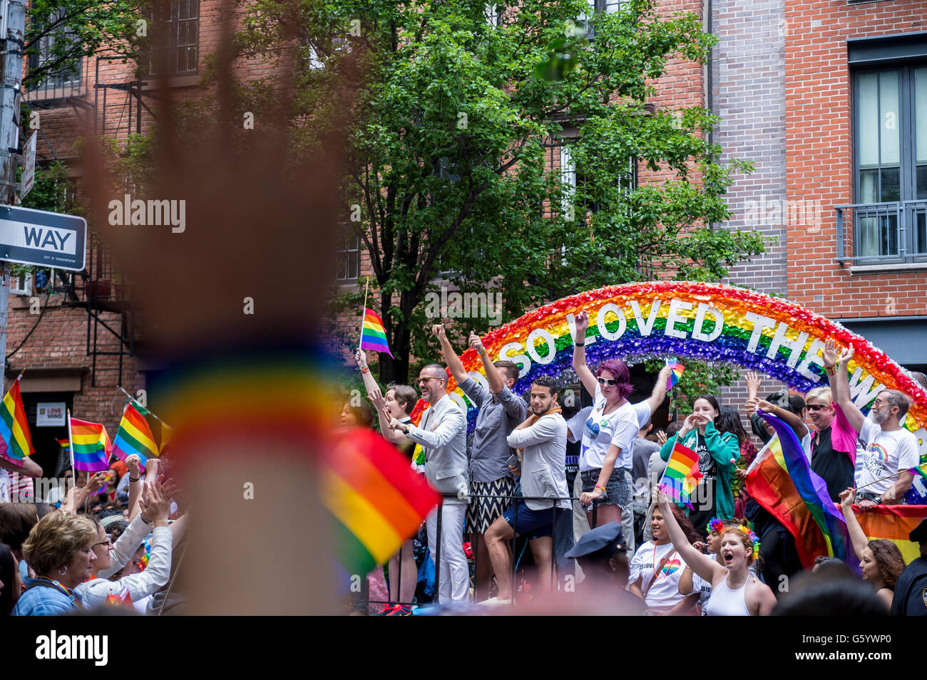 NEW YORK - 28 juin 2015 : lors de l'Assemblée célébrants gay pride parade des drapeaux arc-en-ciel vague lorsqu'ils passent devant les spectateurs. Banque D'Images
