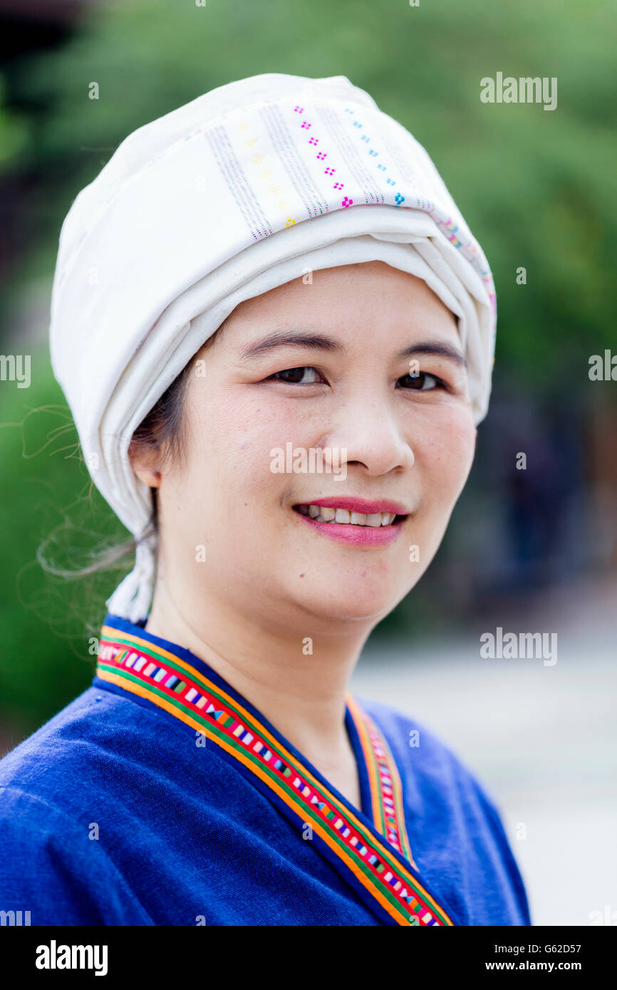 Thaïlande, Nord de la Thaïlande, région de Chiang Mai. A Tai lue (alias Thai lue / Tai le / Tai Lü / Dai) femme indigène en robe traditionnelle souriant à la caméra Banque D'Images