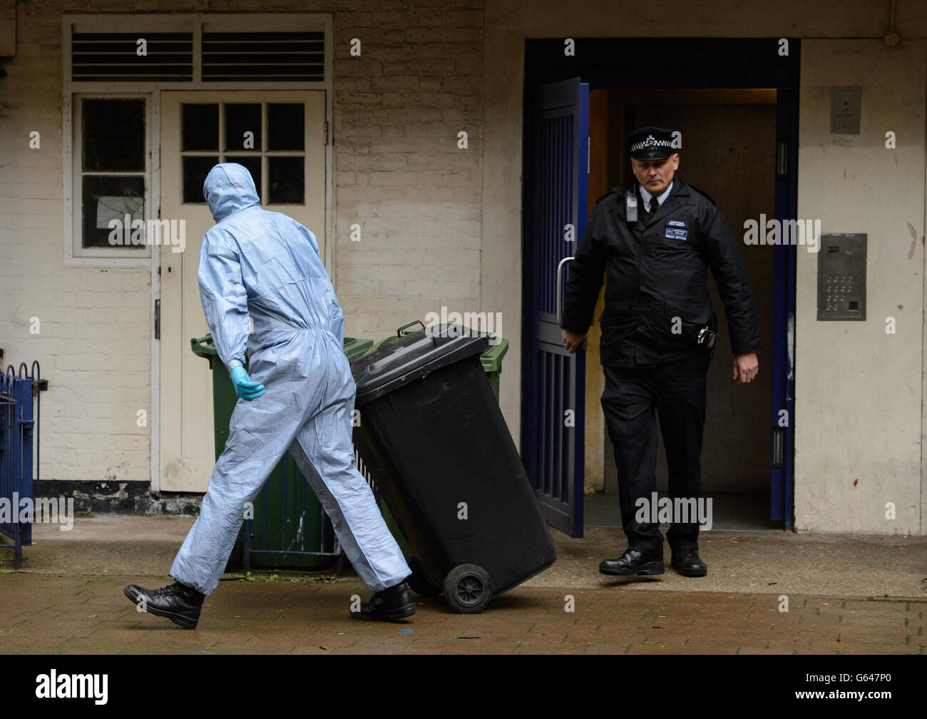 Un policier judiciaire retire des preuves d'un appartement à Macey House, à Greenwich, dans le sud-est de Londres, où Michael Adedowale, 22 ans, est enregistré comme électeur. Banque D'Images