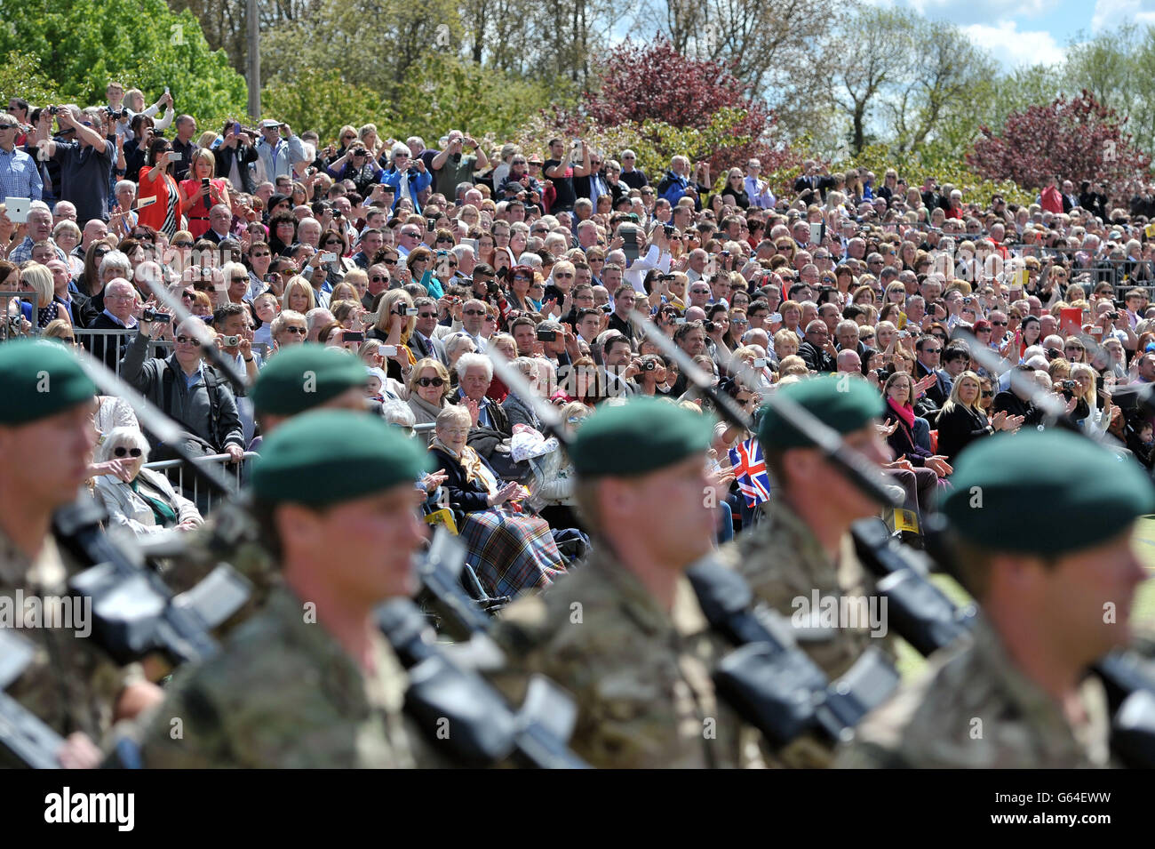 La famille et les amis regardent alors que les membres de 40 Commando arrivent pour un défilé de retour au Norton Manor Camp, Somerset, après leur retour d'Afghanistan. Banque D'Images