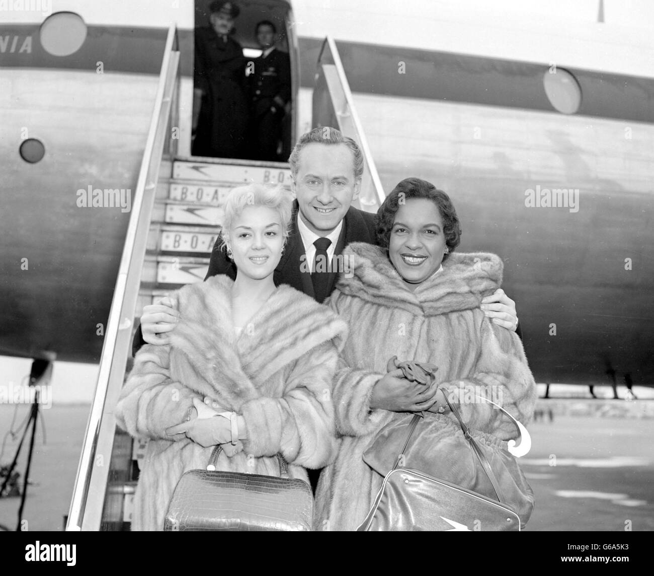 C'est une fête musicale avec une différence - elle est tenue à l'étranger un BOAC Britannia qui a quitté l'aéroport de Londres pour New York. Au cours du vol, un spectacle d'une demi-heure sera enregistré à bord de l'avion et repassera de New York pour être rejoué au Monday Show de Jack Hylton sur ITV, le 17 février. Les stars avec Hughie Green sont (à gauche) Rosalina Neri, chanteuse de Milan, et à droite Winifred Atwell. Banque D'Images