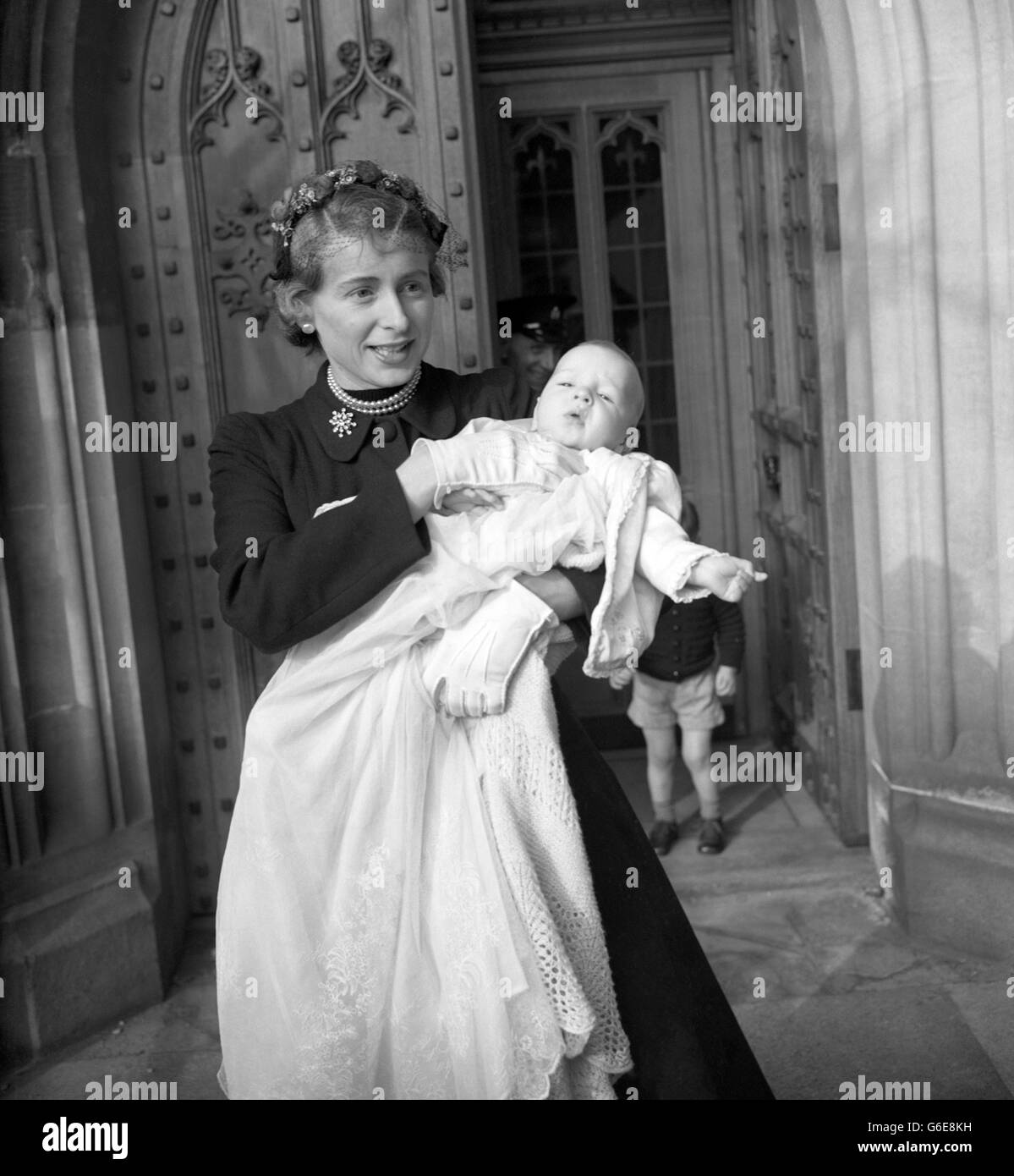 HILARY JAMES, bébé fils de l'honorable Anthony Wedgwood Benn, dans les bras de sa mère après le baptême dans la Chapelle Crypt de la Chambre des communes, Londres.L'honorable Anthony est député travailliste de la division du Sud-est de Bristol. Banque D'Images