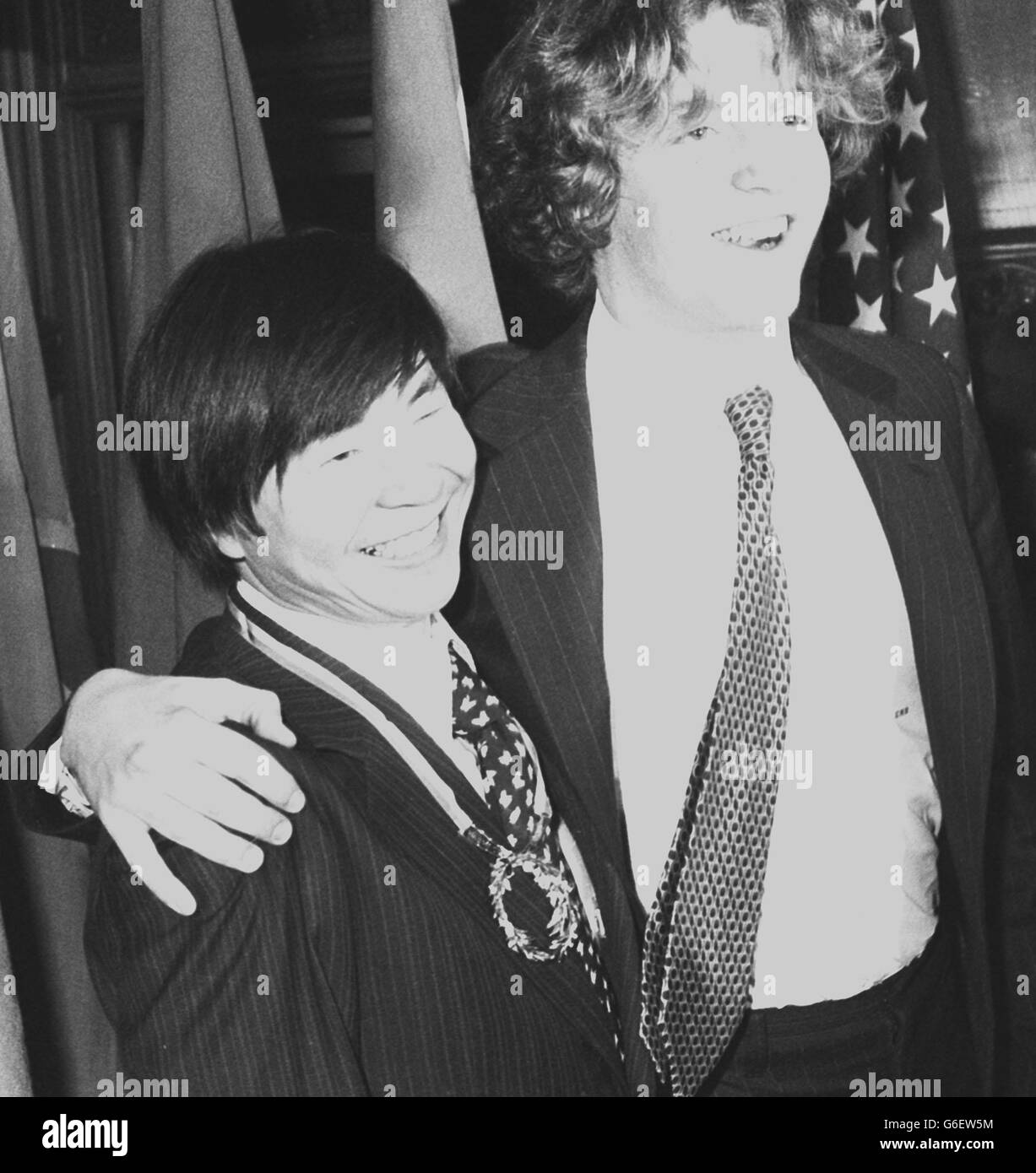 L'alpiniste japonais Naomi Uemura (à gauche) reçoit un hug de Teddy Kennedy, 17 ans, fils du sénateur américain Edward Kennedy à Guidhall à Londres, après que l'homme de 37 ans ait remporté le prix International pour la Valor dans le sport -- V.C. du sportif -- pour sa réalisation en devenant le premier homme à faire le voyage solo au pôle Nord à travers la mer gelée de l'arctique. Teddy, qui avait une jambe amputée en 1973 après la détection du cancer, était l'un des nominés pour le prix -- une couronne de Laurier d'or évaluée à 55,000. Banque D'Images