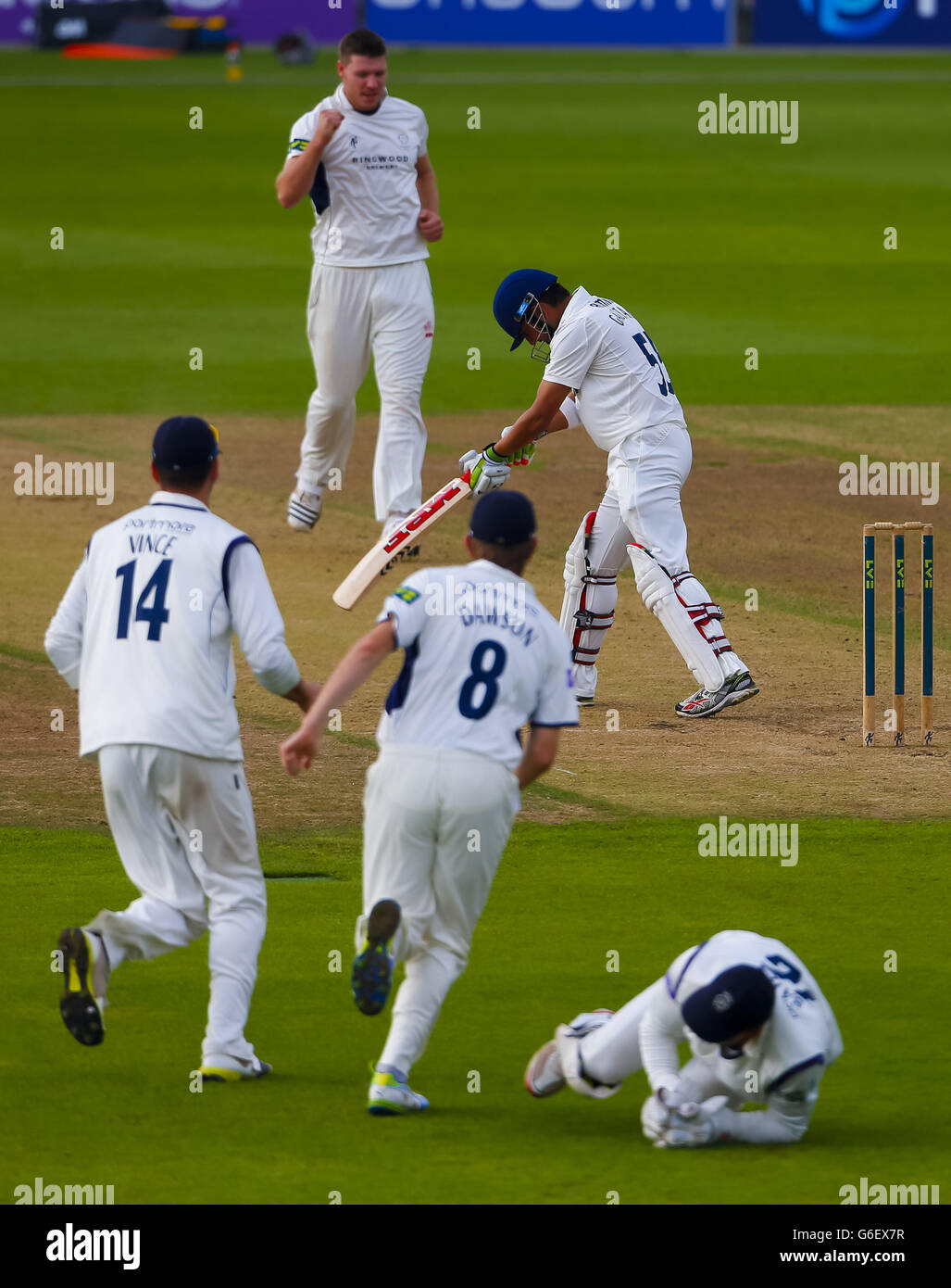 Matt Coles du Hampshire (en haut) célèbre le cricket du batteur d'Essex Gautam Gambhir pour trois courses, capturées par le gardien de cricket Michael Bates (sur le terrain) lors du match LV= County Championship Division Two au Ageas Bowl, à Southampton. Banque D'Images