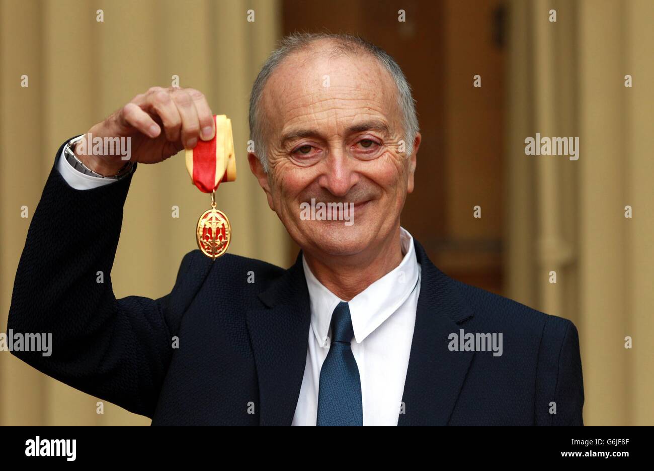 Sir Tony Robinson tient sa médaille après avoir été fait chevalier par le duc de Cambridge lors d'une cérémonie d'investiture à Buckingham Palace, dans le centre de Londres. Banque D'Images