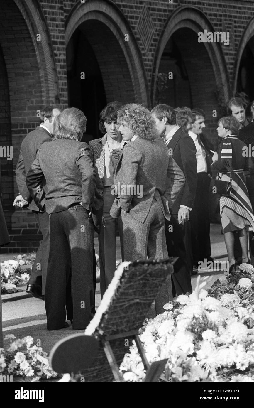 Roger Daltery (r), du groupe de rock The Who, parlant avec Rolling Stones Bill Wyman (face à la caméra) et Charlie Watts (à droite, partiellement caché) au crématorium Golders Green dans le nord de Londres pour assister aux funérailles de Keith Moon, le batteur du groupe de rock anglais The Who, qui est décédé d'une surdose de drogue. 13/09/1978 Banque D'Images