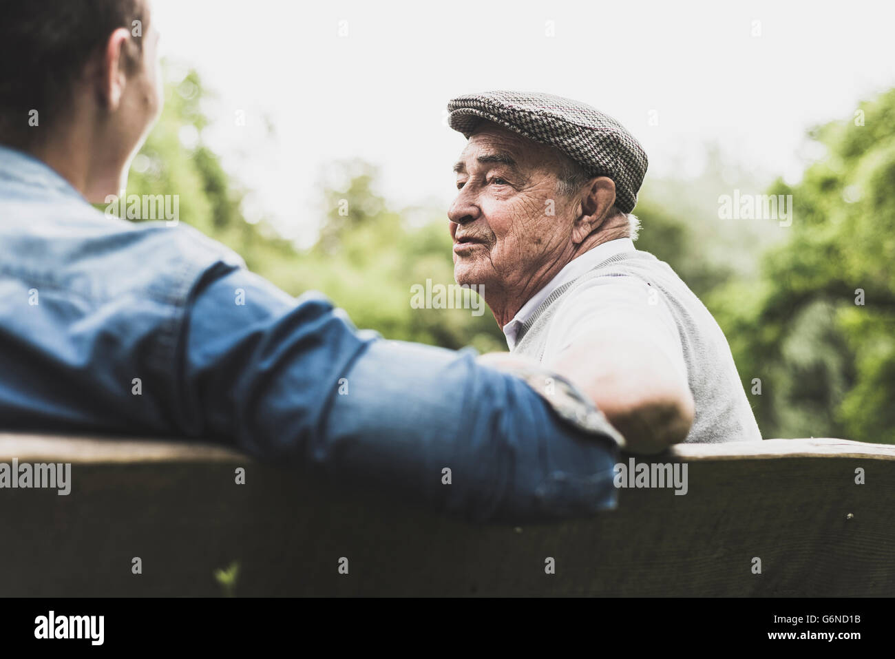 Portrait of senior man talking avec son petit-fils sur un banc Banque D'Images