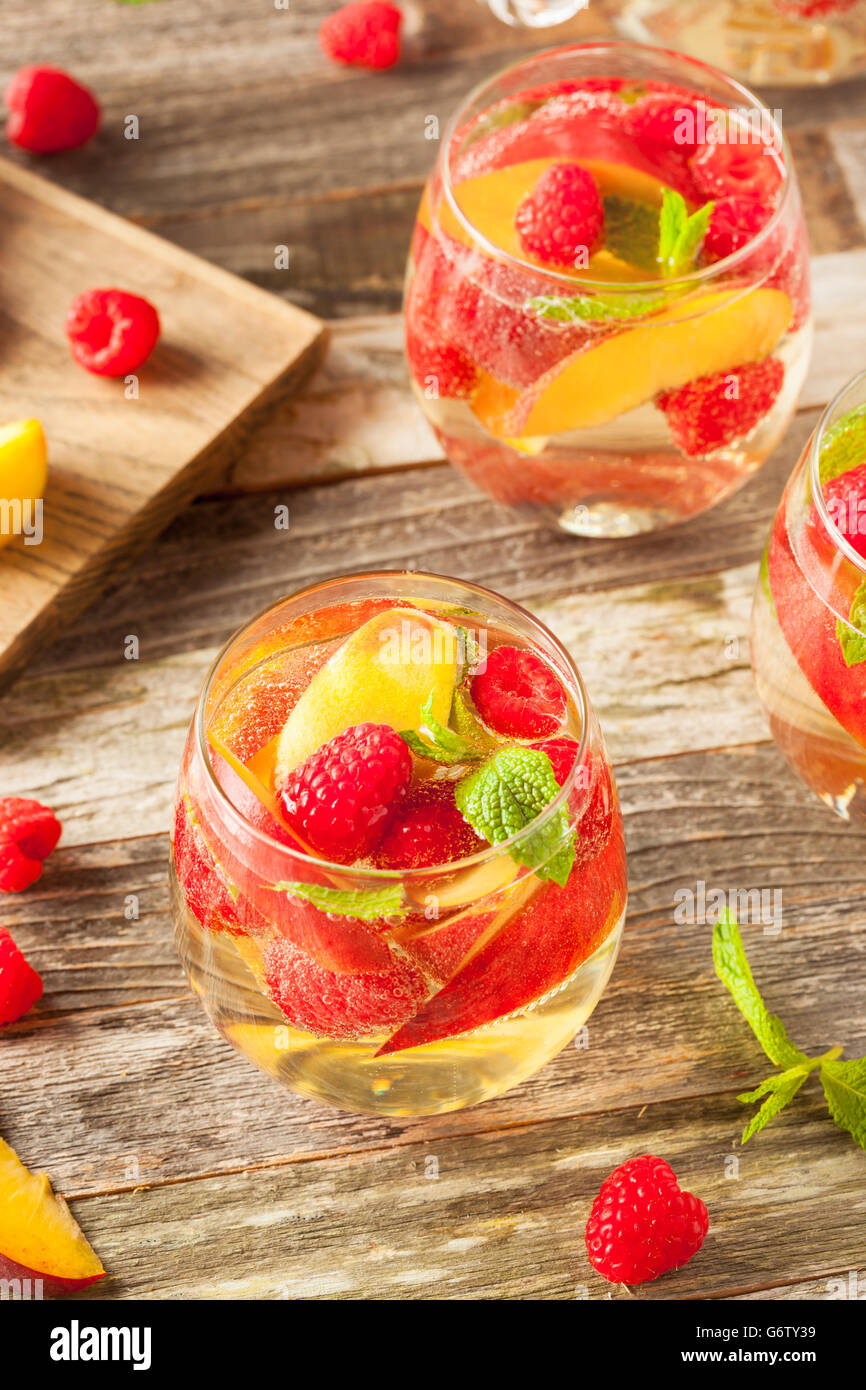Vin blanc mousseux Sangria faite maison avec des pêches et framboises Banque D'Images