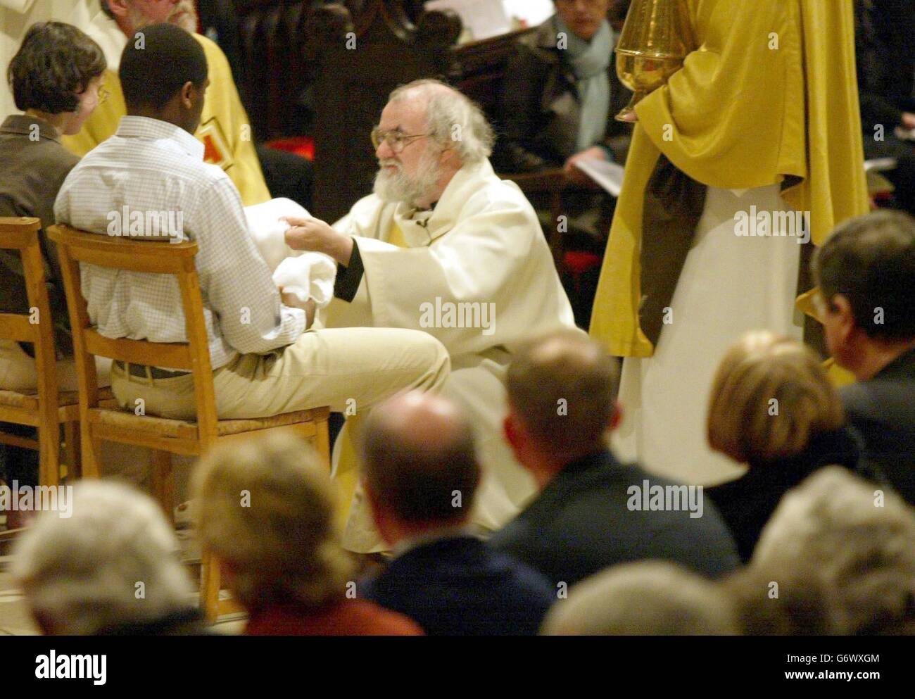 L'Archevêque de Canterbury (au centre), le Dr. Rowan Williams lave les pieds d'un douze adorateurs, jeudi 8 avril 2004, pour recréer Jésus lavant les pieds de ses douze dicièmes dans le cadre du service Maundy à la cathédrale de Canterbury dans le Kent. Banque D'Images