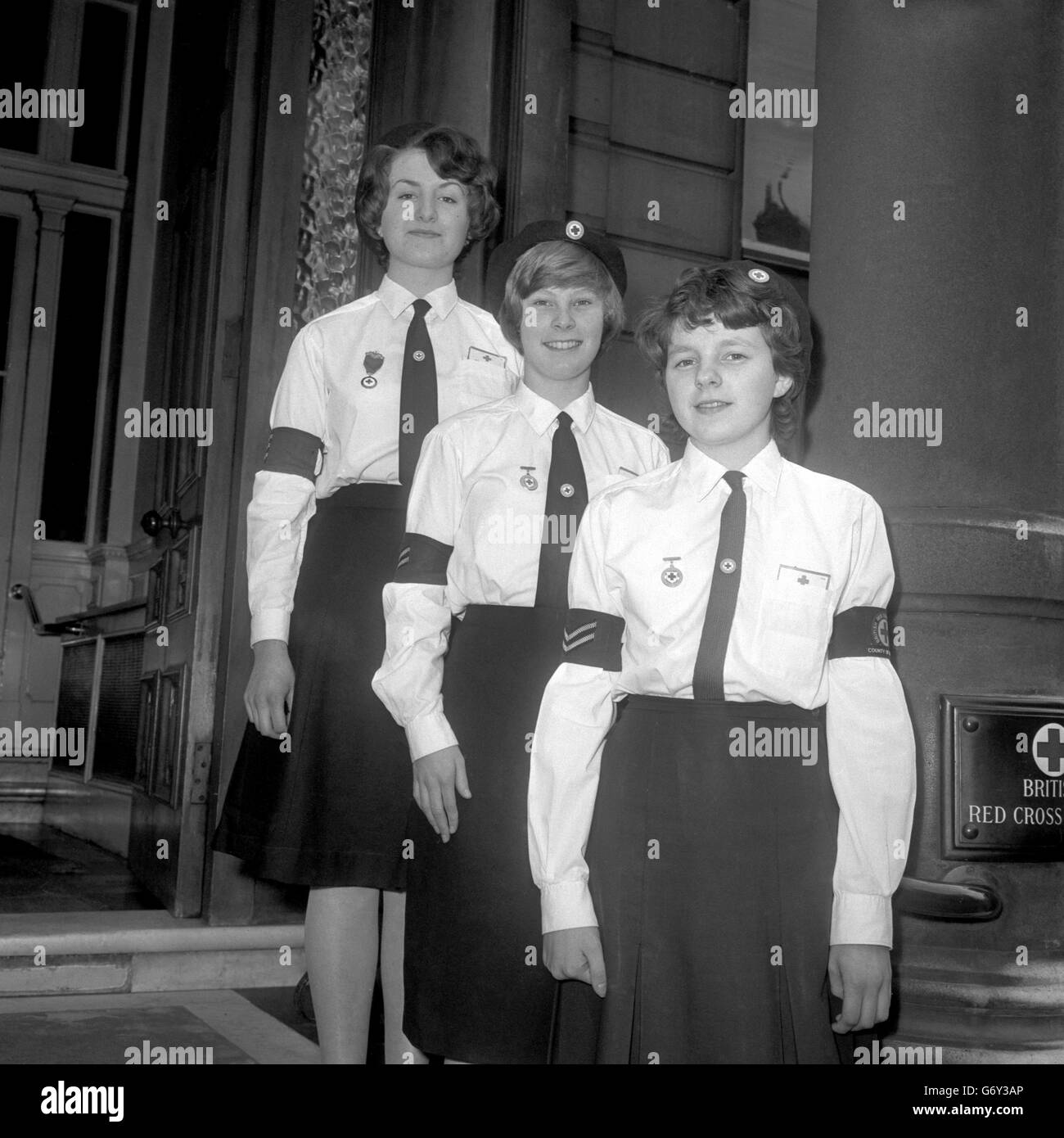 Trois membres de la Croix-Rouge junior britannique qui, avec la permission de leur patron, auront des billets pour un point de vue devant l'abbaye de Westminster lors du mariage de la princesse Alexandria et Angus Ogilvy.La princesse Alexandria est le patron de l'organisation et a donné les billets.Les filles sont (l-r) Penny Clifton, 16 ans, de Croydon, chef de section senior; Barbara Renshaw, 14 ans, également chef de section senior et membre de la succursale de la ville de Londres; et Maureen O'Neill, de Paddington, qui aura 15 ans le jour du mariage royal. Banque D'Images