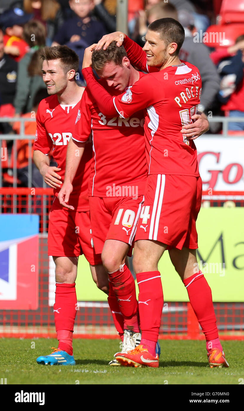 Andy Drury, de Crawley Town (milieu), est félicité par les coéquipiers après avoir marquant son deuxième but. Banque D'Images